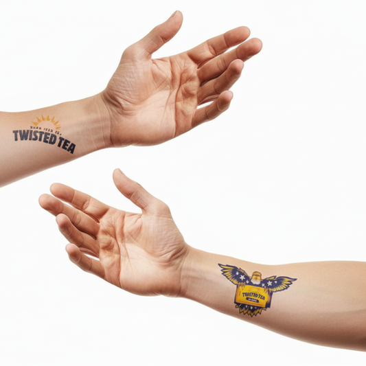 Two forearms with Twisted Tea temporary tattoos are extended against a white background. The top forearm has a Twisted Tea logo tattoo near the wrist. The bottom forearm features a colorful temporary tattoo of an eagle with wings spread on the outer wrist.