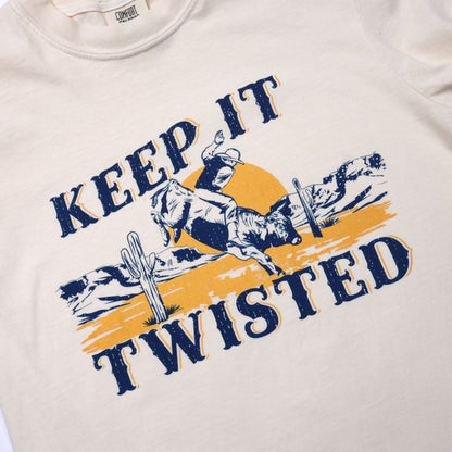 Tee shirt with graphic design of a person riding a bull and text 'Keep It Twisted' on a beige background.