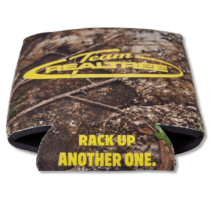 A camouflage can cooler with a woodland tree-bark pattern, featuring a yellow 'Team REALTREE' logo on the top and yellow text reading 'RACK UP ANOTHER ONE.' on the lower flap, shown on a white background.