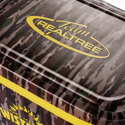 Close-up of a cooler lid featuring a dark camouflage pattern with a yellow Team Realtree logo and a bright yellow zipper line.