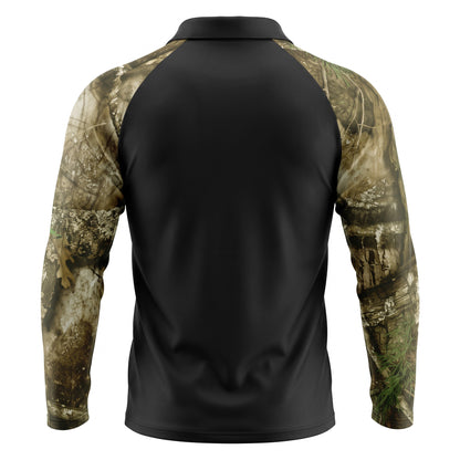 Back view of a long-sleeve athletic pullover shirt with a solid black body and camouflage sleeves in shades of brown, beige, and green, shown on a white background.