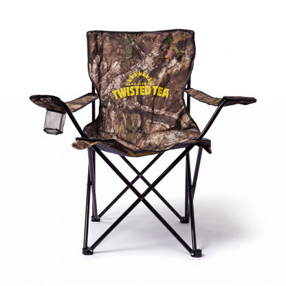 A folding camp chair with a brown and green camouflage pattern, featuring a yellow 'Twisted Tea' logo on the backrest. The chair has black metal legs and armrests, with a small black mesh cup holder on the left armrest, set against a plain white background.