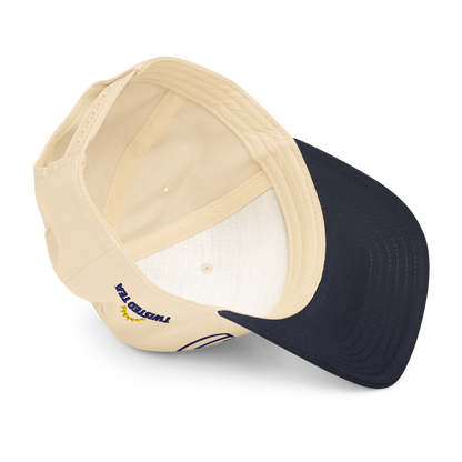 Interior view of Twisted Tea baseball cap showing cream fabric panels, navy brim underside, and branded stitching.