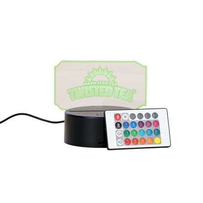 Glowing rectangular light with 'Twisted Tea' branding and a remote control on a white background